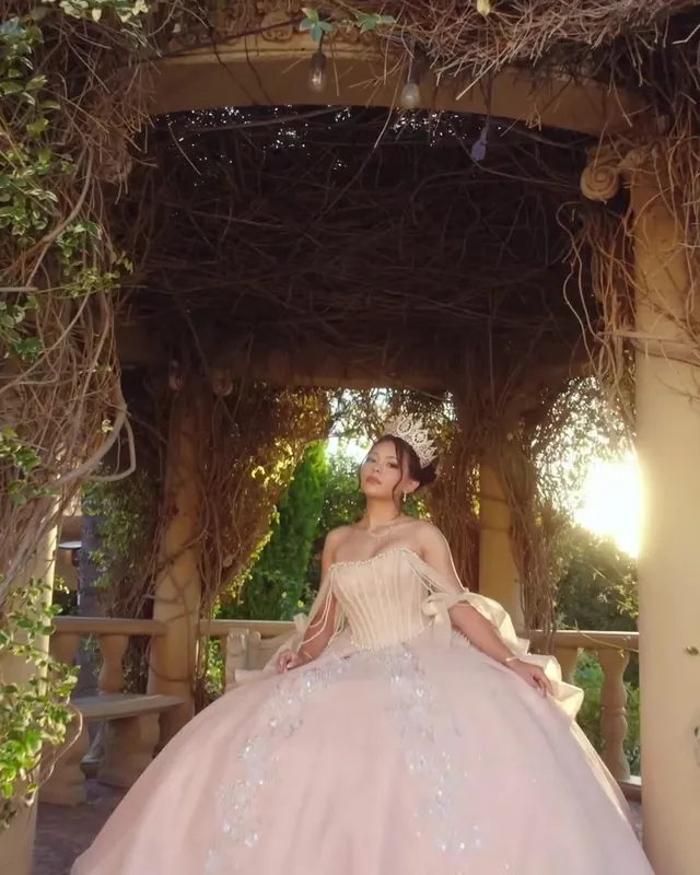 Quinceañera under the ivy-covered arbor at golden hour
