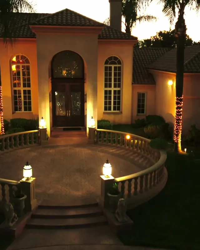 The estate’s front entrance lit at dusk