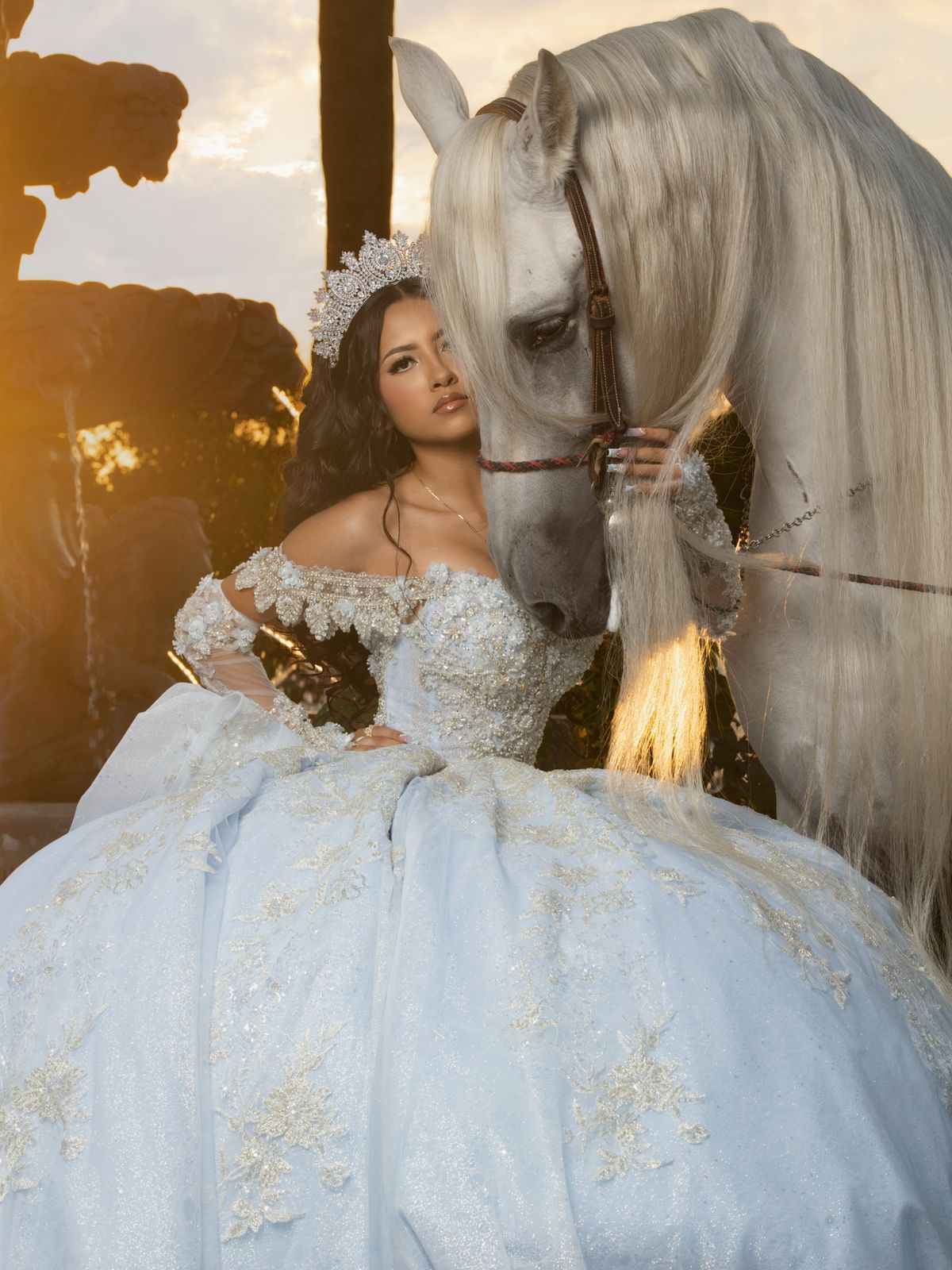 A powder-blue gown, a white horse with a flowing mane and a Mediterranean-style estate at sunset.