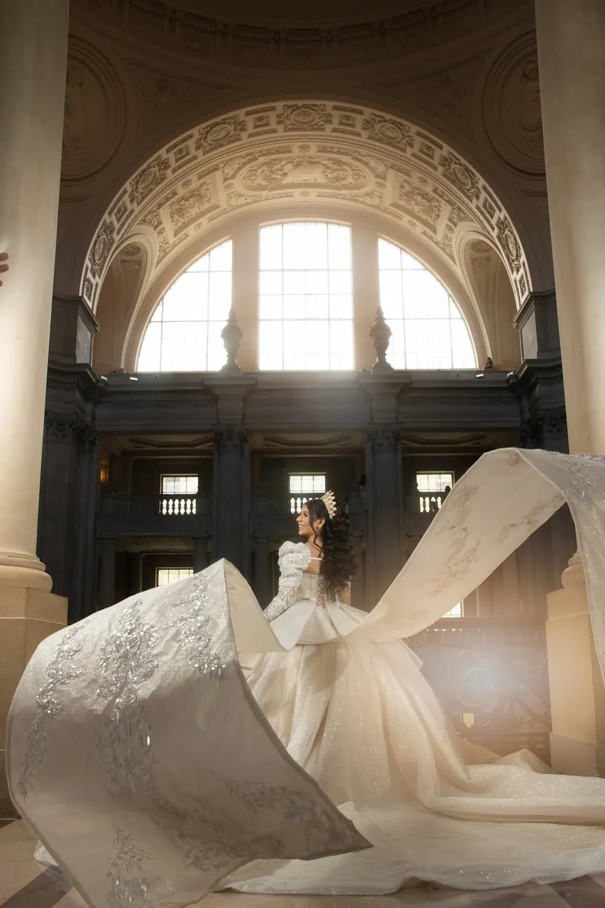 A long train flowing beneath the arched window of San Francisco City Hall