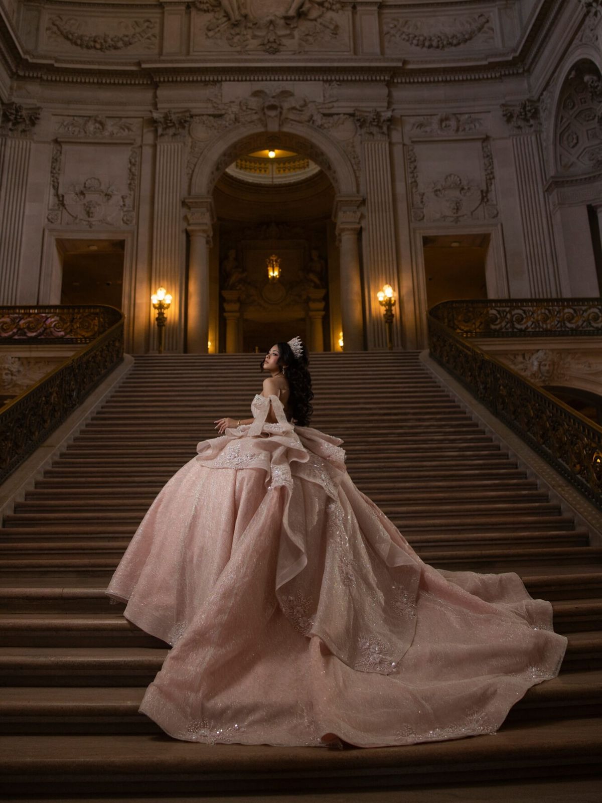 A blush gown among the columns of the Palace of Fine Arts at sunset, then the grand staircase inside City Hall.